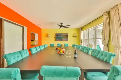 a conference room with a long table and blue chairs at Hollywood Tropical Paradise vibe waterfall pool villa in Hollywood