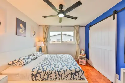 a bedroom with a bed and a ceiling fan at Hollywood Tropical Paradise vibe waterfall pool villa in Hollywood