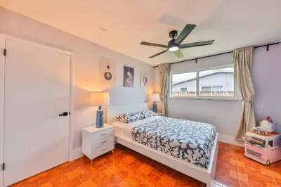 a bedroom with a bed and a ceiling fan at Hollywood Tropical Paradise vibe waterfall pool villa in Hollywood