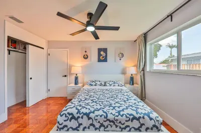 a bedroom with a bed and a ceiling fan at Hollywood Tropical Paradise vibe waterfall pool villa in Hollywood