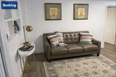 a brown couch in a living room with a rug at Comfort Apartment Miramar in Miramar