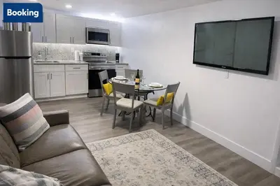 a living room with a couch and a tv on a wall at Comfort Apartment Miramar in Miramar