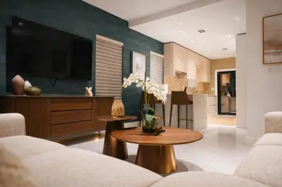 a living room with a couch and a tv at The Rose By Brikell in Miami