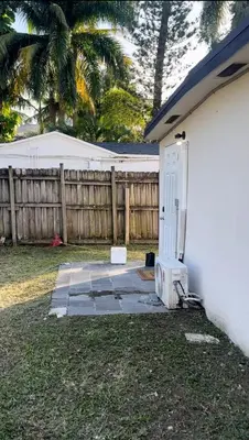 a white house with a door and a fence at Lisboa Shores in Miami
