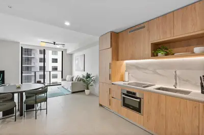 a kitchen with a sink and a table with chairs at Luxury Urban Comfort at The Crosby Miami - Central Location in Miami
