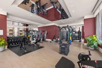 a gym with a lot of treadmills and machines at Luxury Urban Comfort at The Crosby Miami - Central Location in Miami