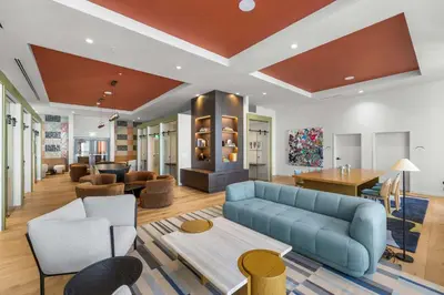 a living room with a blue couch and a table at Luxury Urban Comfort at The Crosby Miami - Central Location in Miami