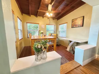 a dining room with a table and a piano at Coconut Villa in Hollywood
