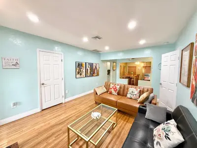 a living room with a couch and a table at Coconut Villa in Hollywood