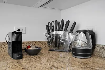 a kitchen counter with a blender and other kitchen utensils at Urban Oasis 2BR Loft Residence in Brickell in Miami