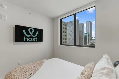 a bedroom with a bed and a window at City View Condo - Prime Downtown Miami in Miami