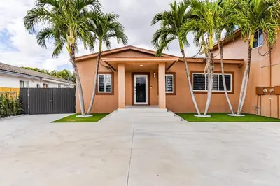 a house with palm trees in front of it at Villa Shallat in Miami