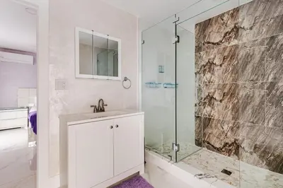 a bathroom with a sink and a glass shower at Villa Shallat in Miami