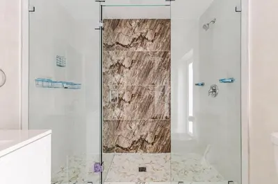 a shower with a glass door in a bathroom at Villa Shallat in Miami
