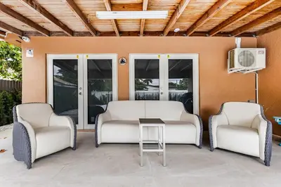 a patio with two chairs and a table at Villa Shallat in Miami