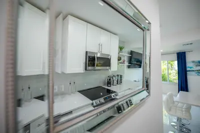 a kitchen with white cabinets and a counter top at Walkable 1BR Apt near Las Olas - Fast WiFi & AC in Fort Lauderdale