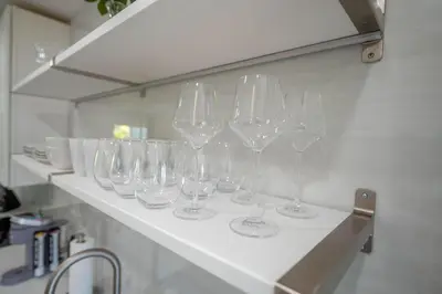 a row of wine glasses sitting on a shelf at Walkable 1BR Apt near Las Olas - Fast WiFi & AC in Fort Lauderdale