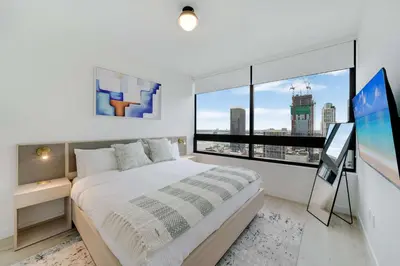 a bedroom with a large bed and a large window at City Atelier -Sauna Pool Parking in Miami
