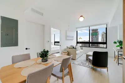 a dining room and living room with a table and chairs at City Atelier -Sauna Pool Parking in Miami