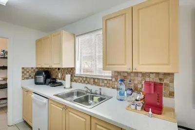 a kitchen with a sink and a counter at Walk to The Big Easy Casino Cozy Apt Near Beaches in Hallandale Beach