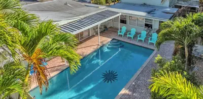 an overhead view of a swimming pool with palm trees and a house at Lazy Cabana- Pool Canal Wilton Drive in Fort Lauderdale