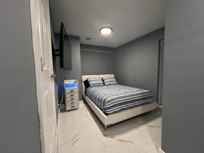 a bedroom with a bed and a dresser in it at Modern apartment near Wynwood in Miami