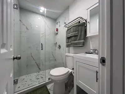 a white bathroom with a toilet and a shower at Modern apartment near Wynwood in Miami