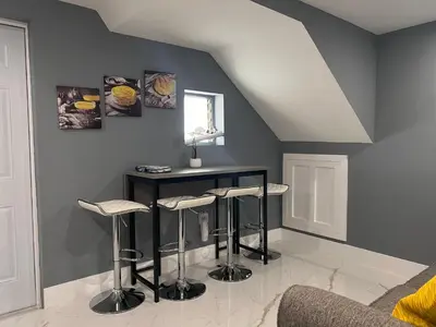 a kitchen with a table and stools in a room at Modern apartment near Wynwood in Miami