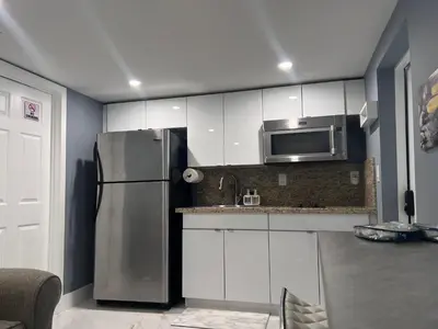 a kitchen with a refrigerator and a microwave at Modern apartment near Wynwood in Miami