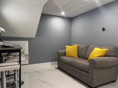 a living room with a gray couch and yellow pillows at Modern apartment near Wynwood in Miami