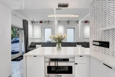 a kitchen with a vase of flowers on a counter at Versace Mansion Neighbor (Floor 1) Sleeps 9 in Miami Beach
