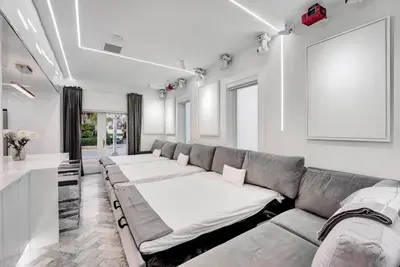 a living room with a couch and a table at Versace Mansion Neighbor (Floor 1,2,3) Sleeps 21 in Miami Beach
