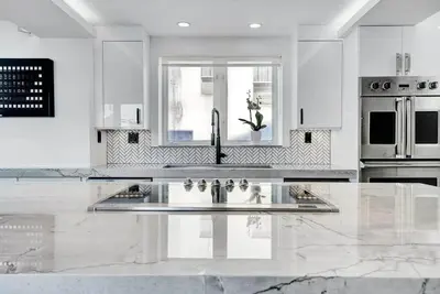 a white kitchen with a sink and a window at Versace Mansion Neighbor (Floor 1,2,3) Sleeps 21 in Miami Beach