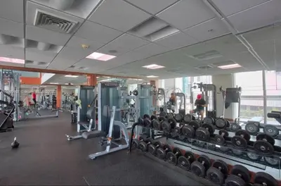 a gym with lots of equipment and people in it at Brickell Residence 2BR Loft with amazing views in Miami
