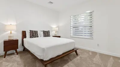 a white bedroom with a bed and a window at Riverside Veranda by AvantStay Waterfront Stay Infinity Pool Private Dock Easy Beach Access in Dania Beach