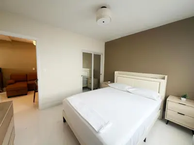a bedroom with a large white bed and a couch at MB Playa Hotel & Apartments in Miami Beach