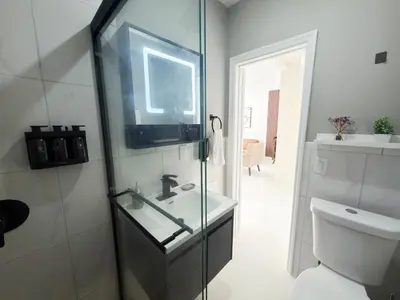 a bathroom with a sink and a toilet and a window at MB Playa Hotel & Apartments in Miami Beach