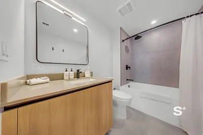 a bathroom with a sink and a toilet and a tub at Downtown Miami Cozy Retreat with Views in Miami