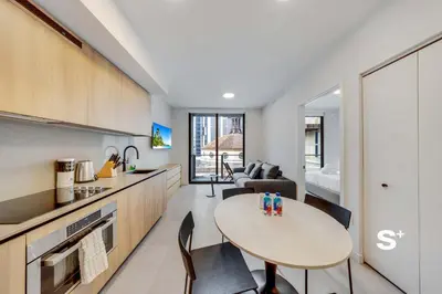 a kitchen and living room with a table in a room at Downtown Miami Cozy Retreat with Views in Miami
