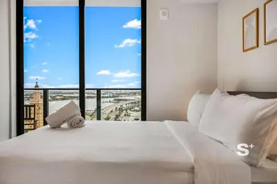 a bedroom with a large white bed with a large window at Downtown Miami Cozy 1BR with Views in Miami