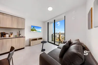 a living room with a couch and a large window at Downtown Miami Cozy 1BR with Views in Miami
