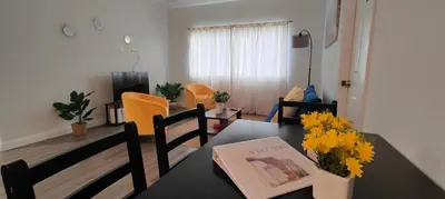 a dining room table with a book and flowers on it at Spacious 3BR-2BA Apt near Downtown-Miami Airport in Miami
