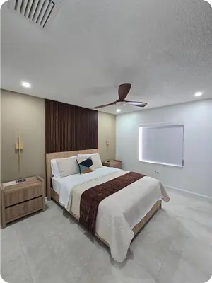 a bedroom with a large bed with a ceiling fan at Chacon in Miami
