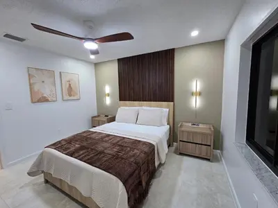 a bedroom with a bed and a ceiling fan at Chacon in Miami