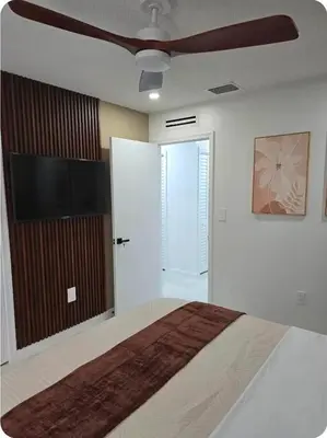 a bedroom with a bed and a flat screen tv at Chacon in Miami