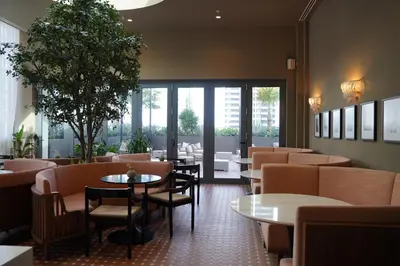 a restaurant with tables and chairs at Stylish Minimalist 1BR in The Crosby in Miami