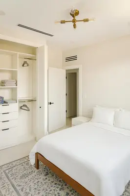 a white bedroom with a bed and a closet at Art District Stay Wynwood & Design District Nearby in Miami