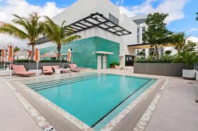 a swimming pool in front of a house at Brand new Studio at The Crosby Miami Worldcenter in Miami