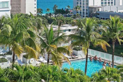 an aerial view of a swimming pool with palm trees at The W 1906 in Fort Lauderdale