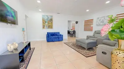 a living room with a couch and a blue chair at Modern & Central Miami Free Parking & WiFi in Miami